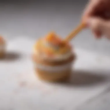 An artist sketching unique cupcake liner designs on a notepad with colored pencils