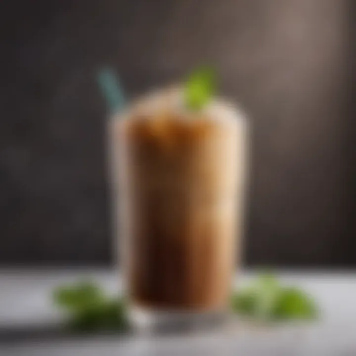 An elegant glass filled with iced coffee garnished with mint.