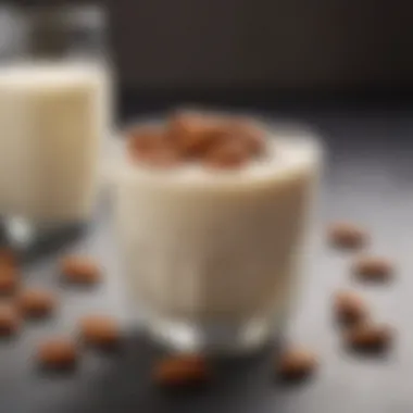 A bowl filled with almonds and a glass of almond milk, showcasing their natural connection.