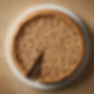 An overhead view of choc chip cookie cake being sliced, revealing its gooey chocolate center