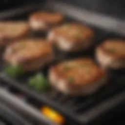 Sizzling pork chops on a stove with herbs