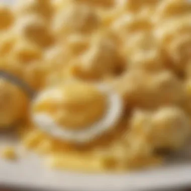 A close-up of a forkful of fluffy scrambled eggs