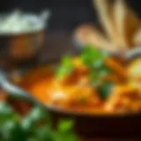 A vibrant bowl of chicken curry garnished with fresh herbs