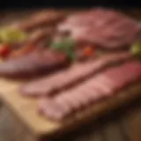 A selection of various meats suitable for smoking, laid out on a rustic wooden surface.