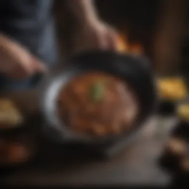 A person holding a seasoned cast iron skillet, showcasing its shiny surface