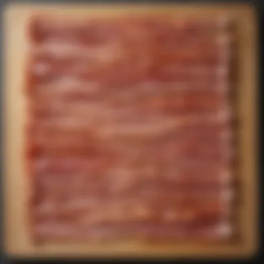 A variety of bacon types arranged on a wooden board