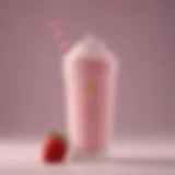 A close-up view of a McDonald's strawberry milkshake in a classic cup adorned with the brand's logo