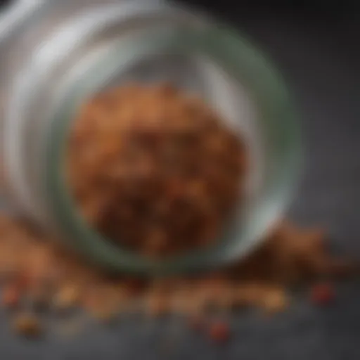 A close-up view of a spice jar filled with Montreal seasoning, highlighting its texture and ingredients.