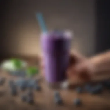 Person holding a glass of blueberry smoothie, emphasizing health benefits