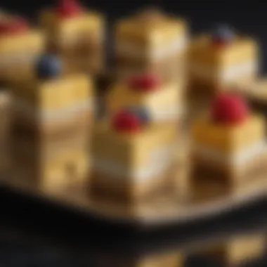 Close-up of a beautifully crafted petit four topped with edible gold leaf and vibrant fruit