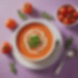 A vibrant bowl of creamy tomato bisque garnished with purple carrot slices and fresh herbs
