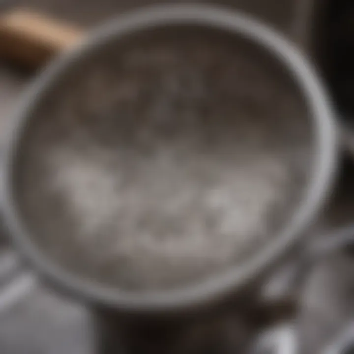 Close-up of a stainless steel strainer being cleaned, emphasizing maintenance