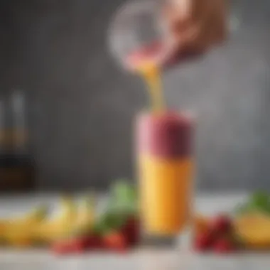 A vibrant smoothie being poured from a travel blender