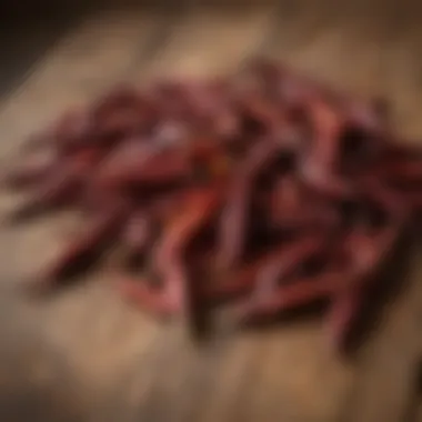 A variety of dried hatch chilies arranged artistically on a rustic wooden table.